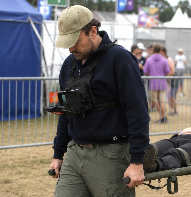 Responder using chest-mounted hands-free field navigation while carrying a patient